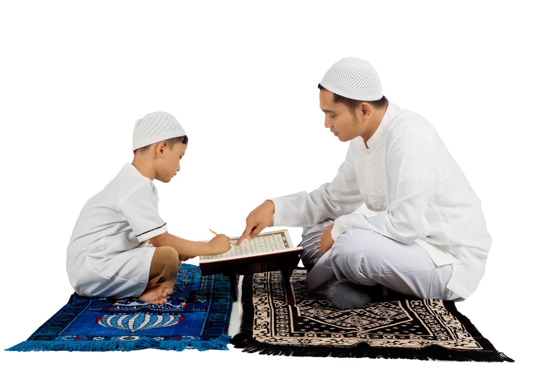 Boy learns to read Quran with father